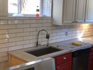 A kitchen sink with new countertop surfaces