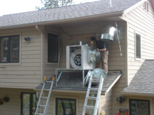A man putting up HVAC parts together