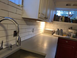 A kitchen sink next to the cabinetry