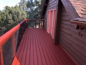 A wooden deck of a house painted in red