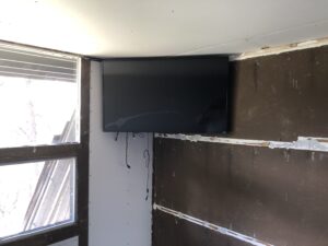 A TV mounted on the corner of a wall